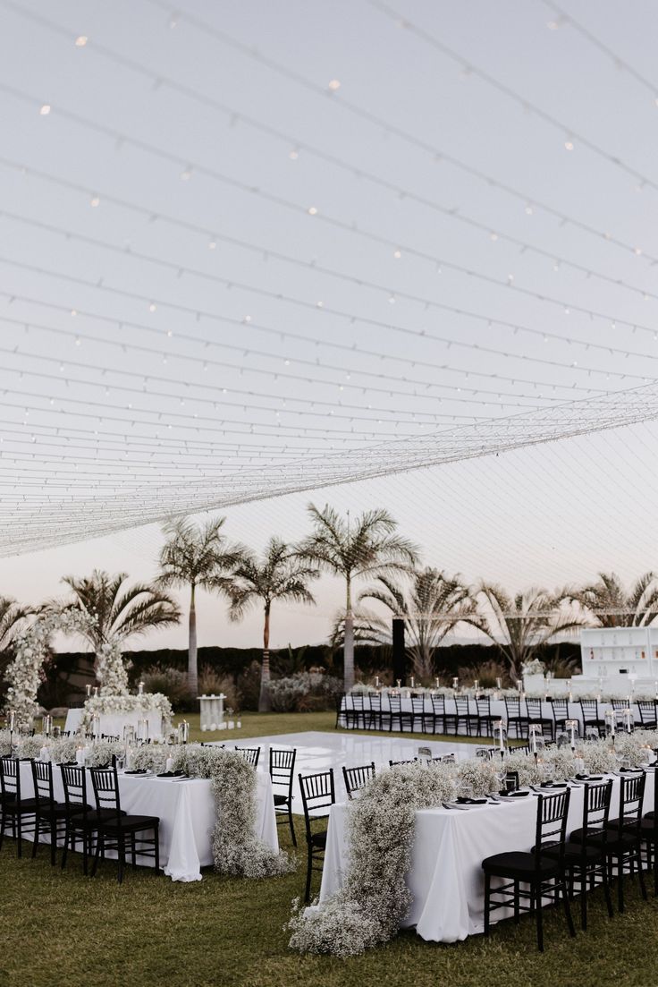 an outdoor wedding setup with tables and chairs