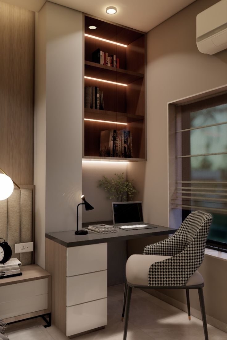 a desk with a laptop computer on top of it next to a chair and window