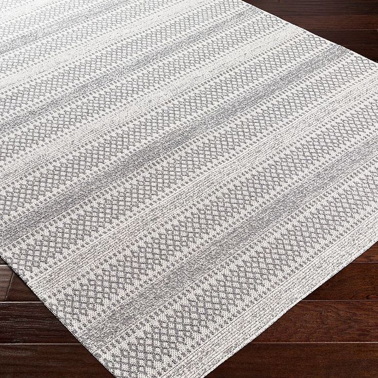 a white rug on top of a wooden floor