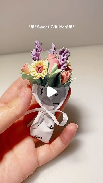 someone is holding a small bouquet of flowers in their hand with the words sweet gift idea written on it