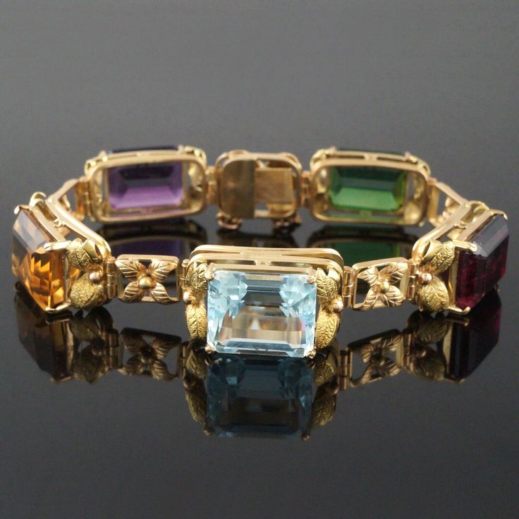 ANOTHER QUALITY ITEM FROM OLDE TOWNE JEWELERS, SANTA ROSA, CALIFORNIA! CHECK OUT OUR OTHER VINTAGE WATCH, JEWELRY, STERLING & ESTATE AUCTIONS!   Large vintage solid 14K yellow gold and synthetic multi precious gemstone link floral and vine motif bracelet in excellent original condition.  Quality, beautifully made estate piece.  Few signs of use, excellent overall.  Please see our high resolution photos, with magnifying option, for your review.      *Synthetic amethyst weight is approximately 9.0 carats. *Synthetic Citrine weight is approximately 9.0 carats. *Synthetic Aquamarine weight is approximately 9.0 carat. *Synthetic garnet weight is approximately 13.0 carat. *Synthetic tourmaline weight is approximately 10.0 carat. *Measures 7" long x 1/2" (14.0mm) wide.  Closes with an integrated Luxury Yellow Gold Multi-stone Bracelet, Luxury Gold Multi-stone Gemstones, Luxury Yellow Gold Multi-stone Bracelets, Luxury Multi-stone Yellow Gold Gemstones, Exquisite Multi-stone Yellow Gold Jewelry, Exquisite Gold Gemstones With Accents, Gold Multi-stone Gemstones In Fine Jewelry Style, Gold Multi-stone Fine Jewelry Gemstones, Yellow Gold Gemstone Accented Bracelet