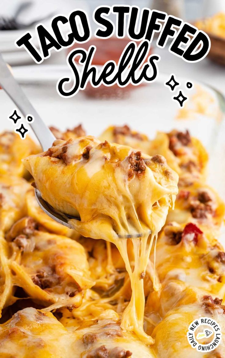 a spoon full of taco stuffed shells on top of a casserole dish