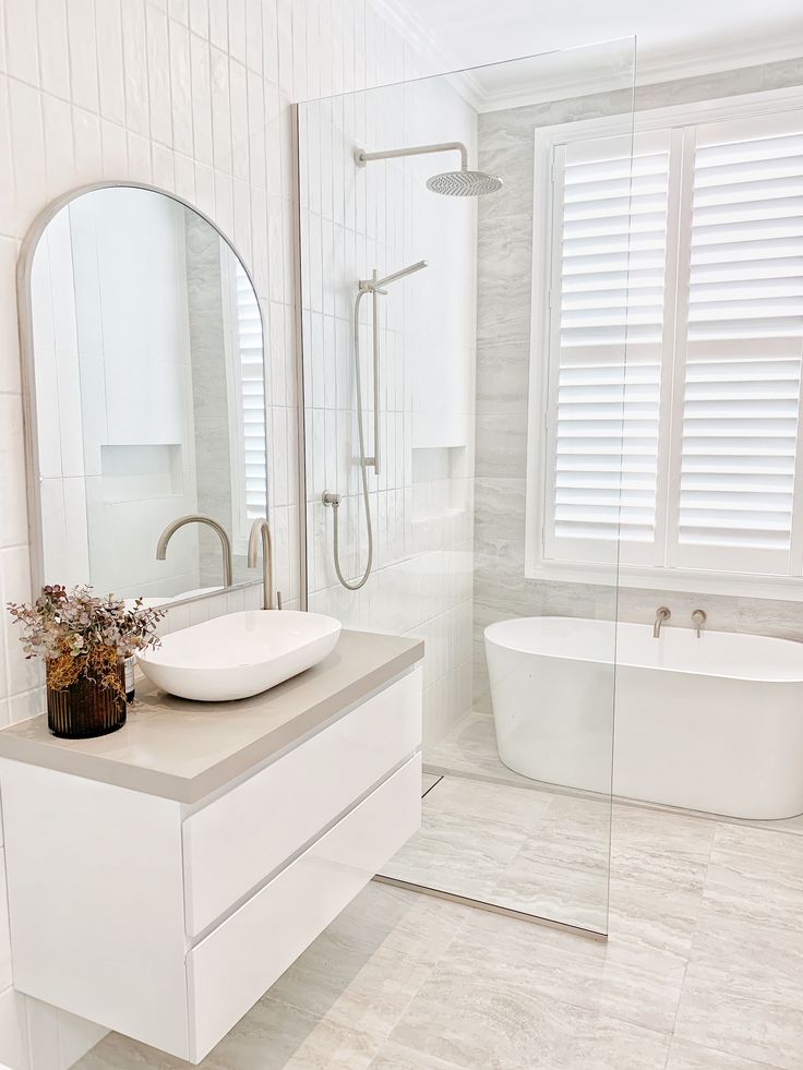 a bathroom with a sink, mirror and bathtub