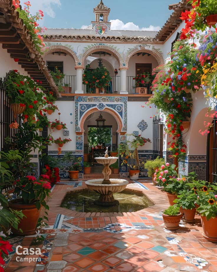 a courtyard with potted plants and a fountain