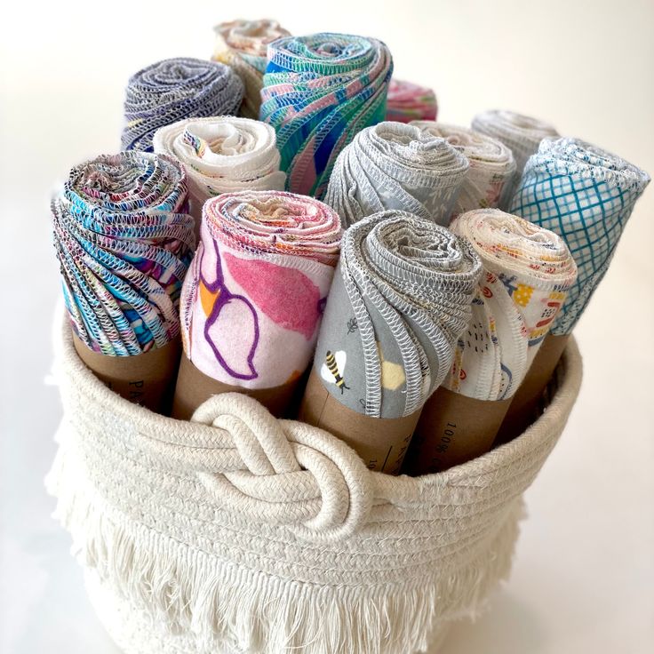 a basket filled with lots of different types of yarn and twine wrapped in burlocks