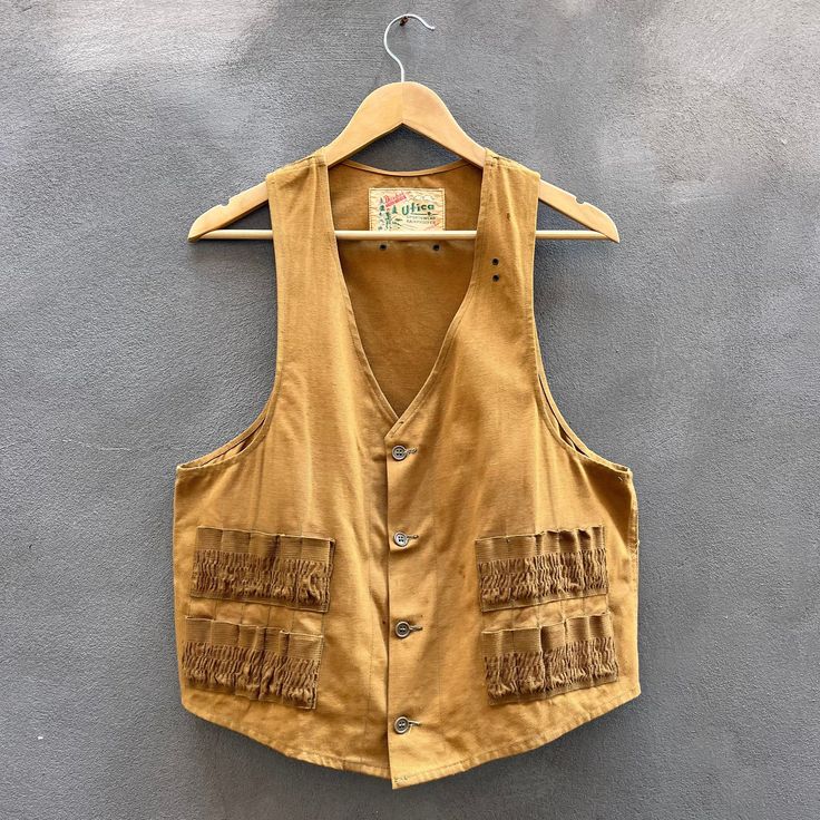 Size: M/L Chest - 20in Length - 24in Sleeveless General wear, check all measurements before purchasing, no refund will be allowed all information is provided in each description. Made in USA, 1950's-1960's tag, and buttons, no major flaws, Duxbak brand Utica sportswear rainproofed, nice brown tan canvas, duck hunting vest, very unique and rare vintage Duxbak vest. Retro Brown Cotton Vest, Retro Sleeveless Cotton Vest, Vintage Sleeveless Brown Top, Vintage Vest With Pockets, Retro Sleeveless Vest With Pockets, Vintage Brown Cotton Vest, Vintage Sleeveless Cotton Vest, Military Field Jacket, Hunting Vest