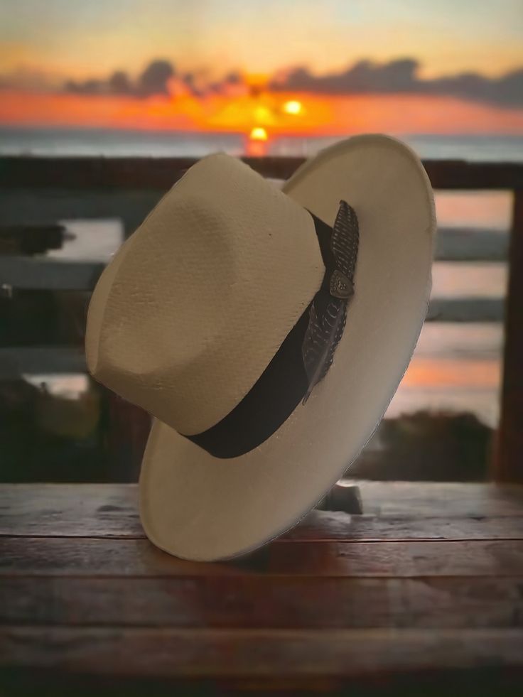 Don't settle for ordinary when you can own something extraordinary. Add this stylish fedora to your collection today and step out with confidence, knowing you're supporting artisanal craftsmanship and making a sustainable fashion choice. Your new Dobbs Feathered Straw Fedora awaits - a hat as unique and creative as the community it comes from. Order now and tip your brim to a world of style! Beige Felt Hat For Summer Rodeo, Fitted Flat Brim Panama Hat For Beach, Western Flat Bill Straw Hat For Beach, Western Style Straw Hat For The Beach, Western Style Straw Hat For Beach, Casual Flat Brim Felt Hat For Beach, Classic White Felt Hat For Beach, Classic Wide Brim Felt Hat For Beach, Flat Bill Fedora In Toquilla Straw For Vacation