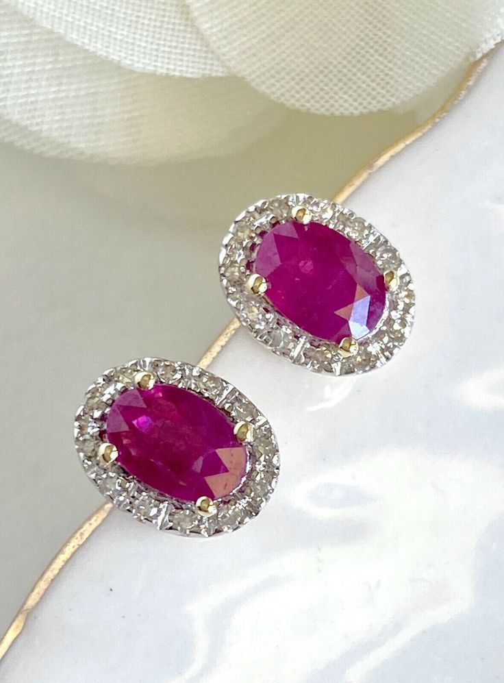 "Natural Ruby (1.10ct) Diamond Halo Solid 14k Yellow Gold Stud Earrings, New* These beautiful earrings are made of solid 14k yellow gold and features 2pcs, genuine, natural, oval, ruby gemstones measuring 4 mmx 5.75mm (1.10ct). These earrings have a classic design with a 24pc diamond halo of single-cut gemstones (I, VS2, 0.10ctw). These earrings are studs with pushbacks for closures, they measure 0.33\"x 0.22\" and weigh 1.95 grams. The gemstones are natural and have inclusions, the color satura Luxury Oval Ruby Earrings, Oval Red Diamond Earrings For Anniversary, Red Oval Diamond Earrings For Anniversary, Yellow Gold Oval Diamond Earrings With Gemstone, Oval Ruby Earrings With Halo Design, Red Oval Halo Design Earrings, Hallmarked Oval Diamond Earrings, Classic Oval Diamond Earrings Aaa Quality, Aaa Quality Oval Diamond Earrings