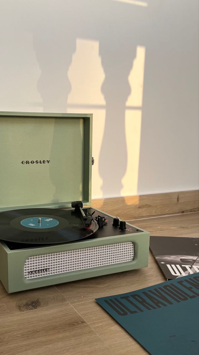 an old record player sitting on the floor