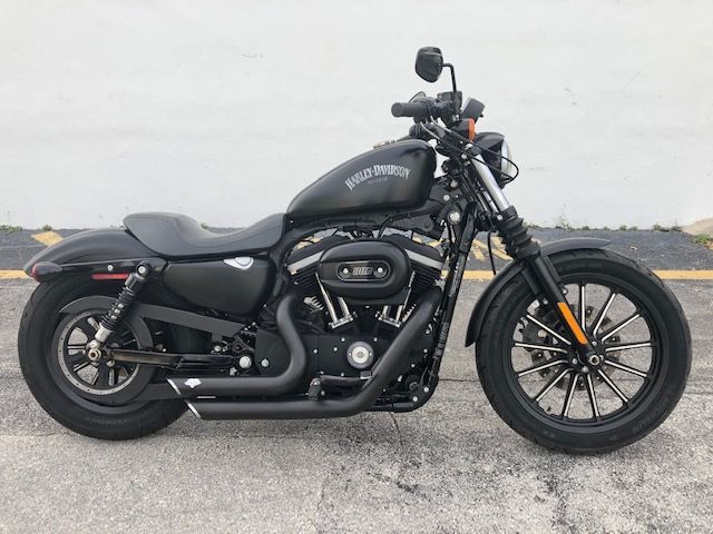 a black motorcycle is parked on the street