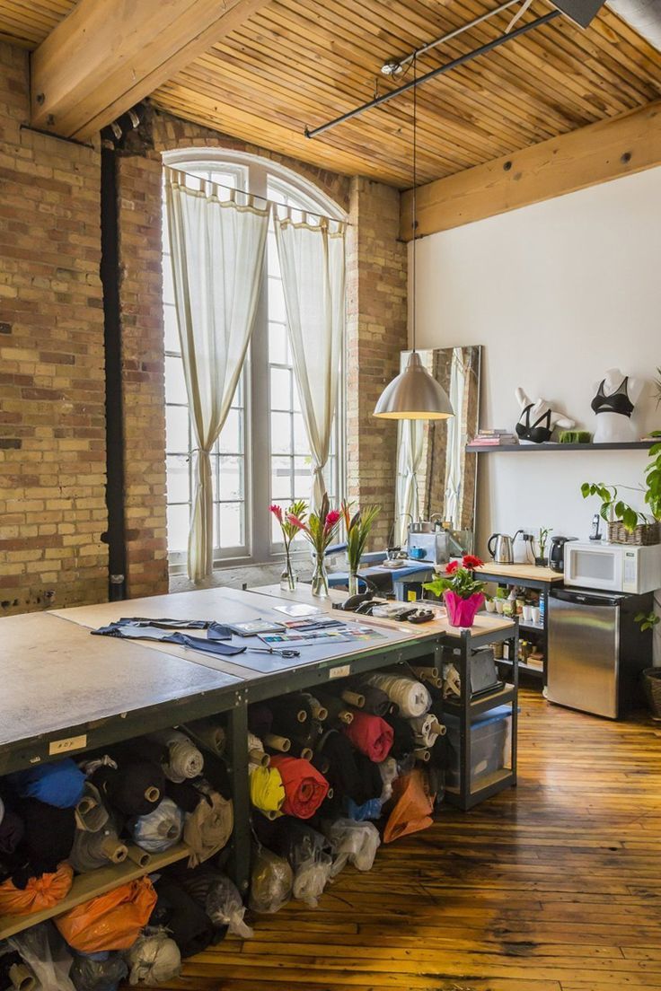 a room filled with lots of shoes on top of a wooden floor next to a window