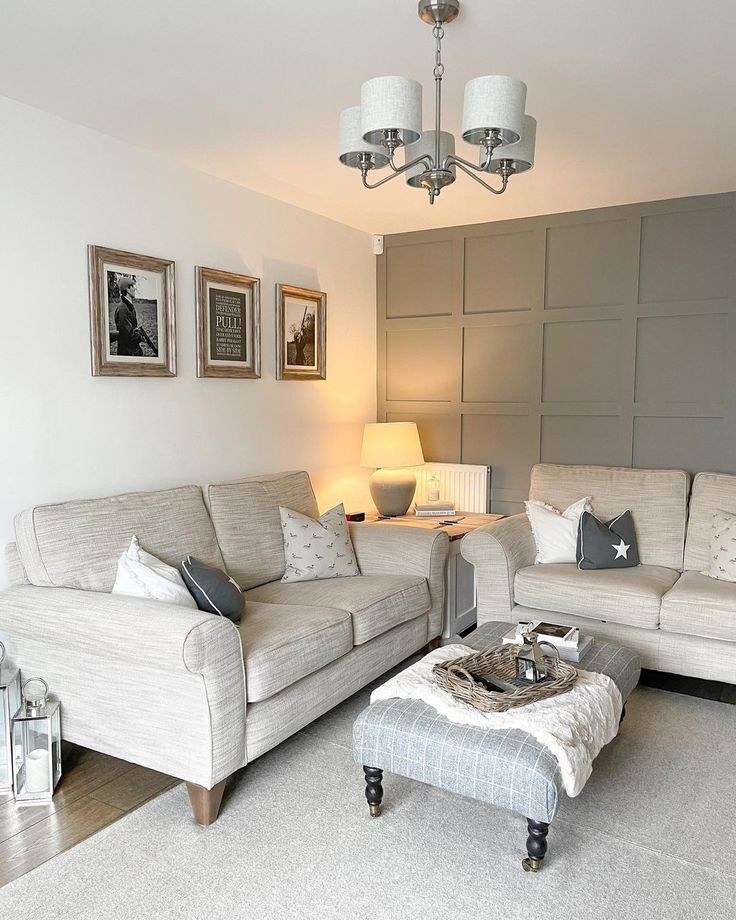 a living room with two couches and a coffee table in front of a wall