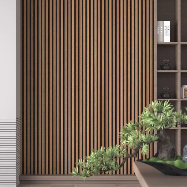 a living room with bookshelves and plants on the table in front of it