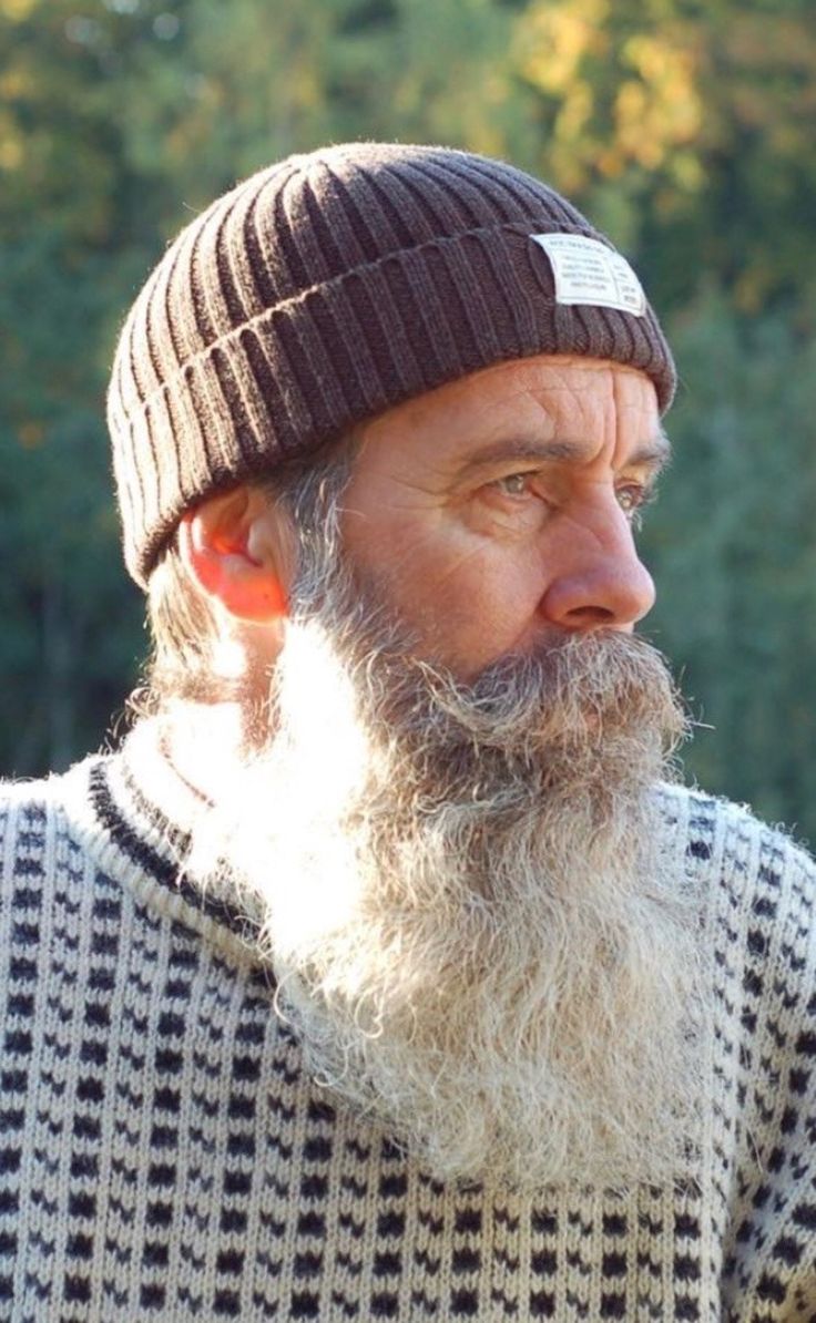 an old man with a long beard wearing a beanie