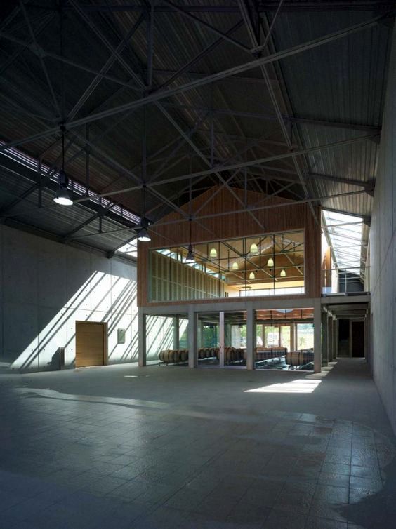 the inside of an empty building with lots of light coming in from the windows and doors