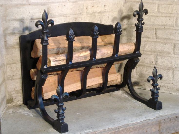 a bench made out of wood and wrought iron on the side of a brick wall