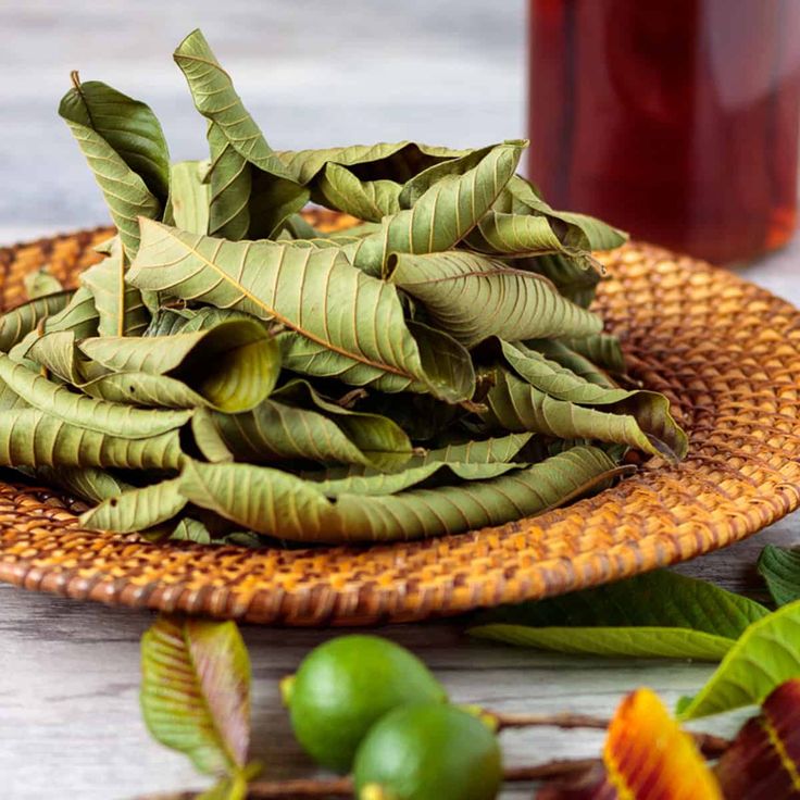 some green leaves are on a brown plate