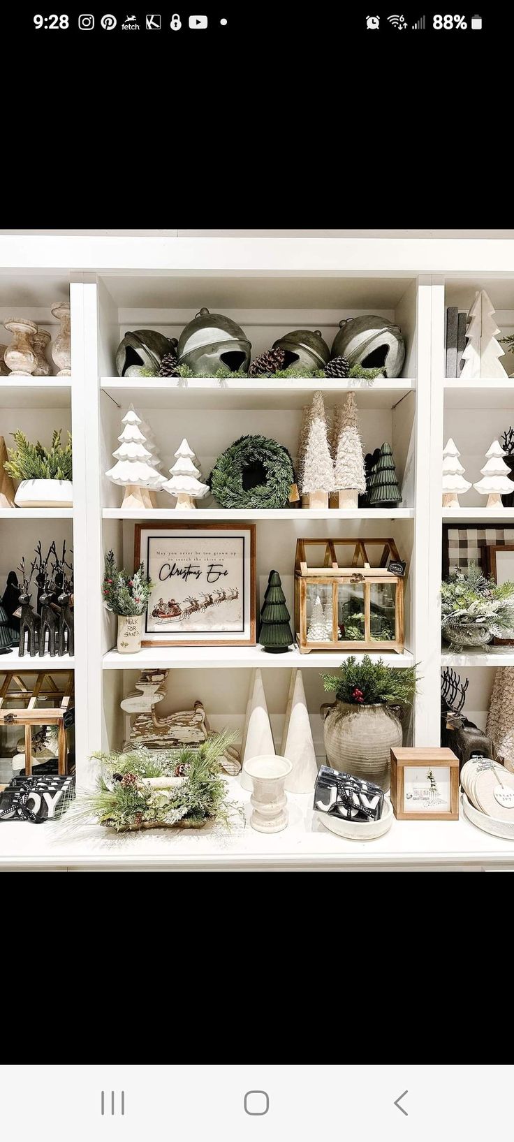 a white shelf filled with lots of christmas decorations on top of it's shelves