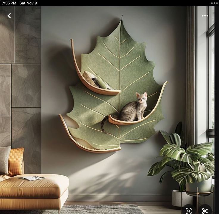 a cat is sitting in a leaf shaped shelf