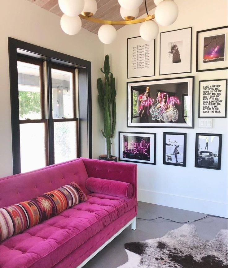 a living room filled with furniture and pictures on the wall