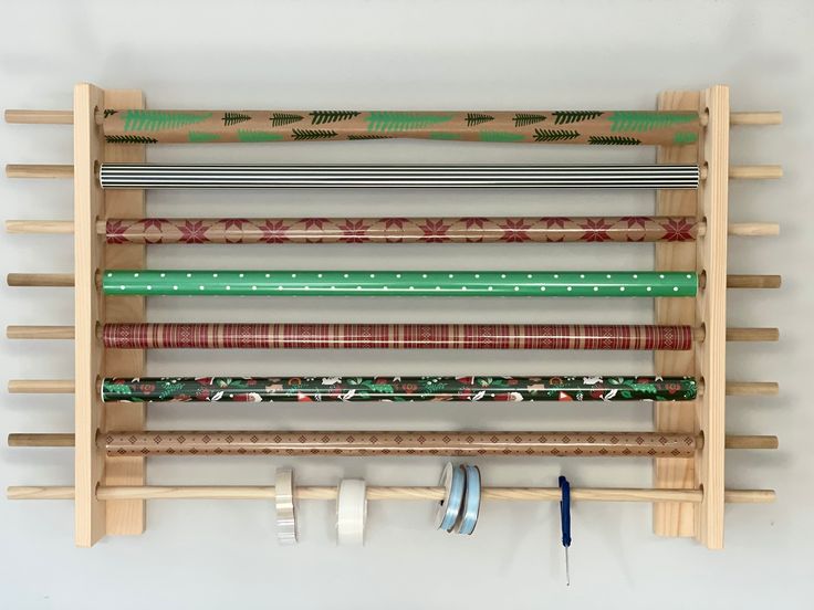 a wooden rack holding several different types of fabric