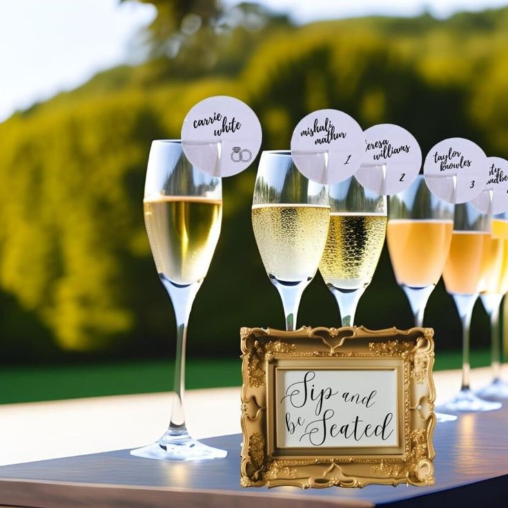 wine glasses are lined up on a table with a sign that says sip and smell