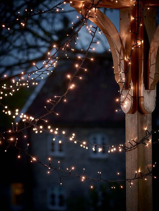 an outdoor gazebo with lights on it at night