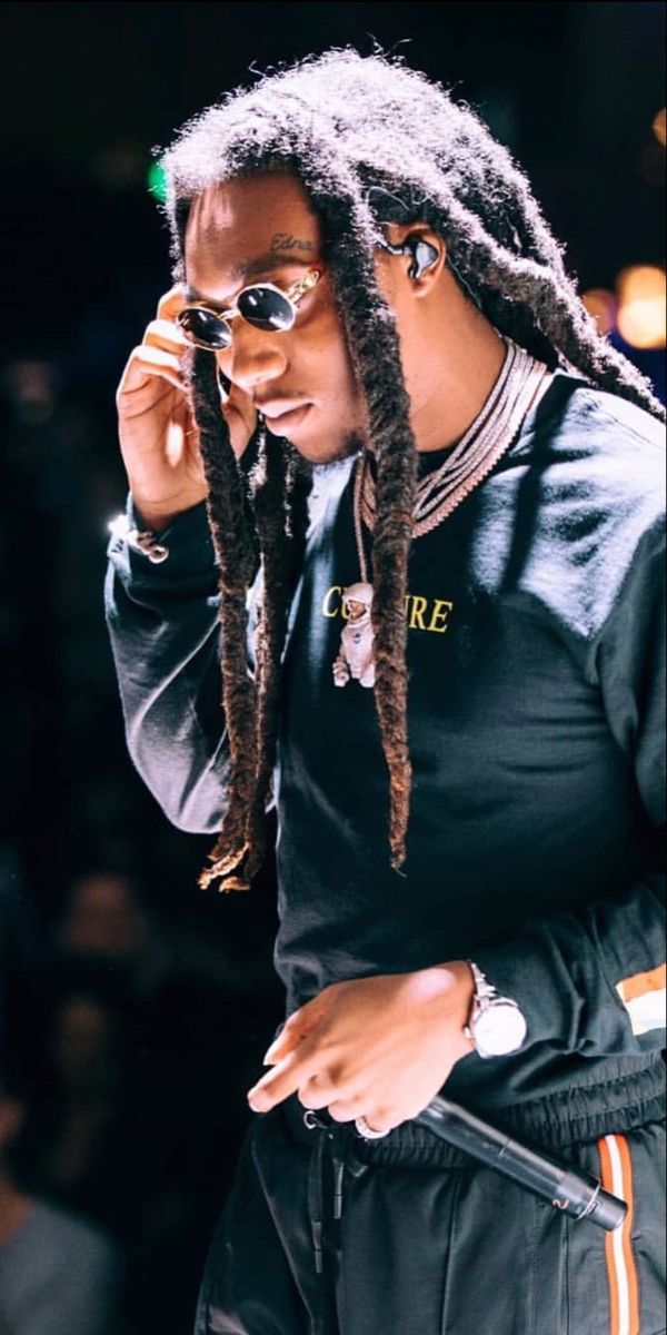 a woman with dreadlocks talking on her cell phone