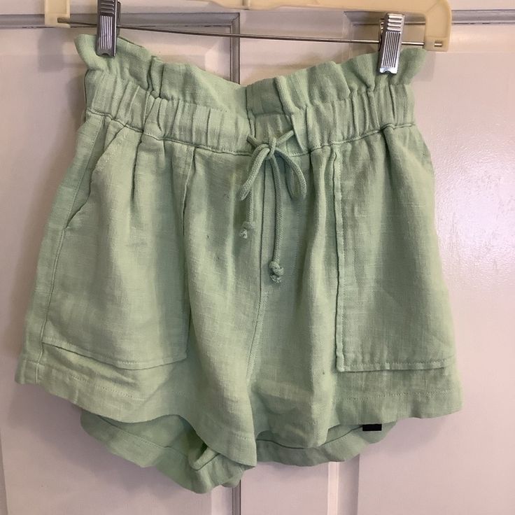 New With Tags These Blank Nyc Women's Shorts Are A Light Green Color And Made Of 100% Ramie. They Feature A High Waist With A Drawstring Closure, Two Front Pockets, And Two Back Pockets. The Shorts Have A Relaxed Fit And Are Approximately 13 Inches Iacross Waist (26) Un-Stretched. The Brand Tag Is Attached To The Shorts And Includes Care Instructions. Light Green Color, Blank Nyc, Brand Tags, Green Color, Women's Shorts, Green Colors, Light Green, Womens Bottoms, Care Instructions