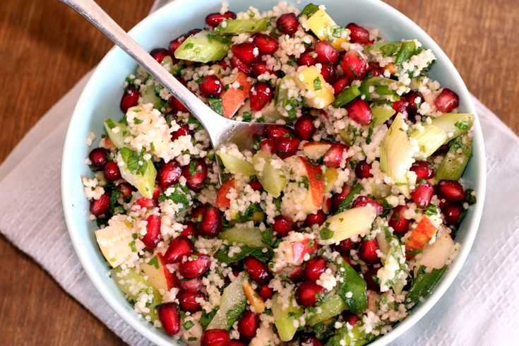 a bowl filled with vegetables and grains on top of a table