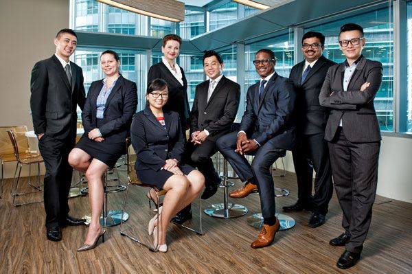 a group of business people posing for a photo