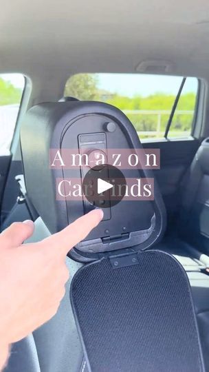 the inside of a car that has an amazon on its back seat and is pointing at it