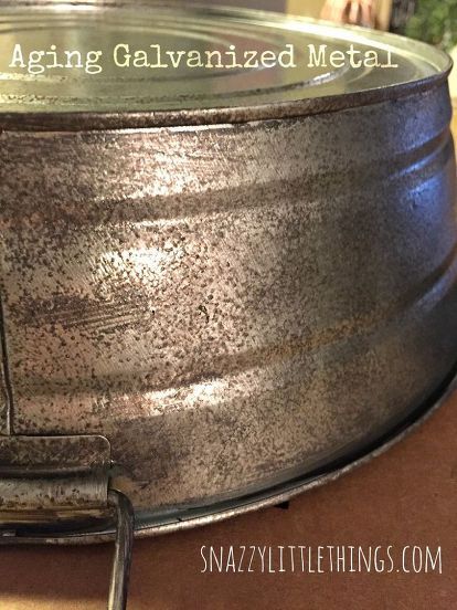 an old galvanized metal bowl is sitting on a table with the words aging galvaniized metal