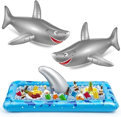 two inflatable shark toys floating on top of an inflatable swimming pool