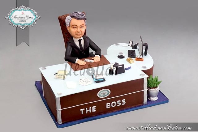 a bobble head sitting at a desk with the boss on it's side