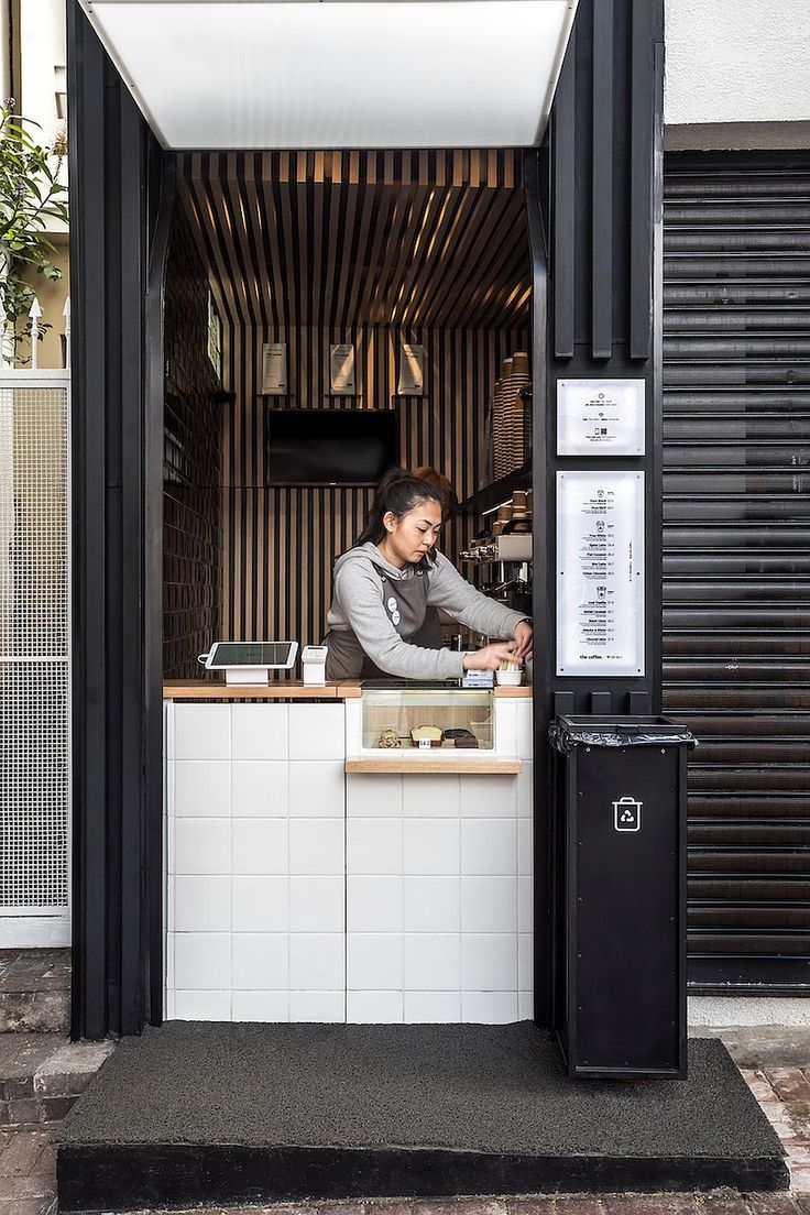 a man standing behind a counter at a restaurant