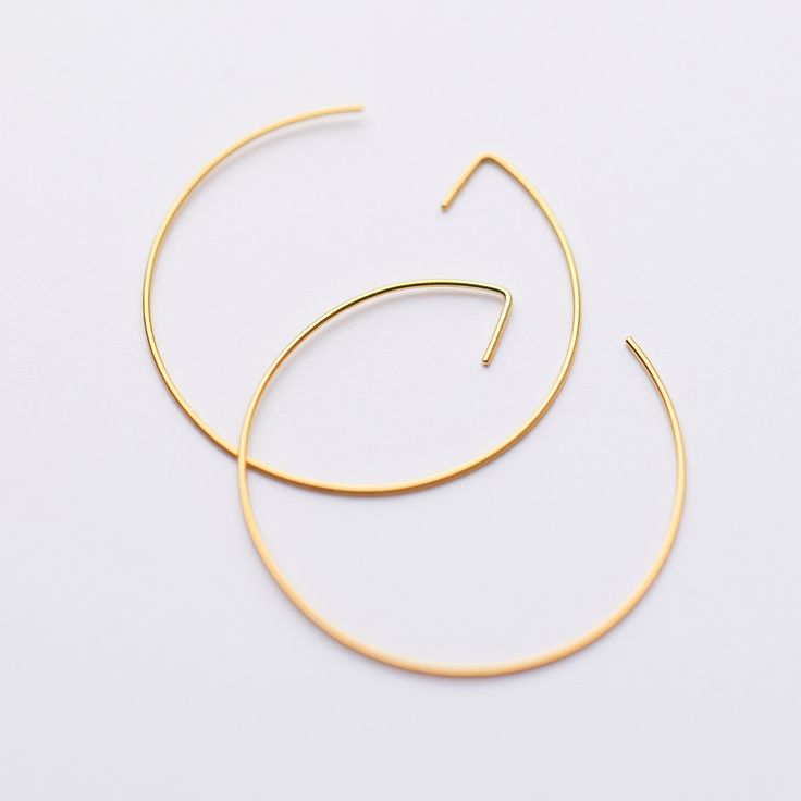 Immerse yourself in the elegance and minimalist charm with our Circle Earring, a jewel that embodies the essence of simplicity blended with the sophistication of modern design. This piece is not merely an accessory; it's a statement of personal style, merging the tranquil allure of minimalist jewelry with the dynamic energy of modern geometric shapes, including the captivating allure of gold threader earrings. For those who value earrings that dangle with purpose and sophistication, our collecti Modern Gold Plated Circle Hoop Earrings, Modern Geometric Single Hoop Earring, Modern Geometric Gold Hoop Earrings, Modern Geometric Jewelry, Gold Threader Earrings, Elegant Semi-circle Brass Earrings, Gold Semi-circle Brass Earrings, Threader Earrings Gold, Edgy Earrings