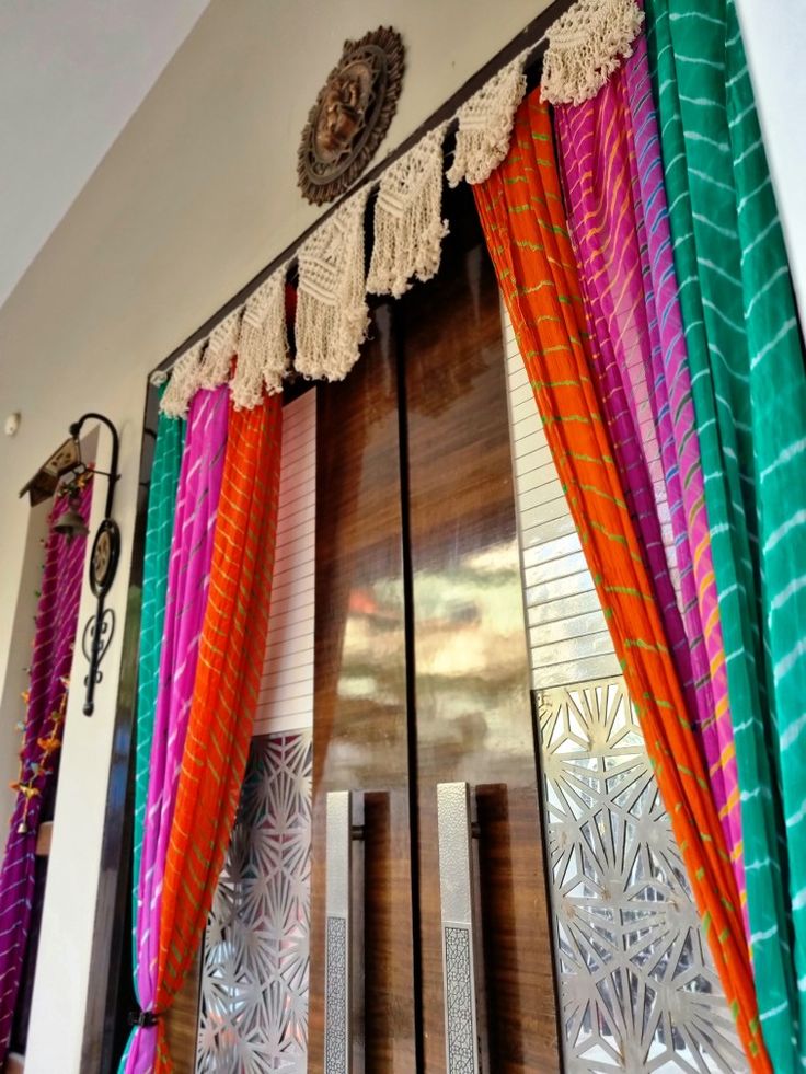 colorful curtains hanging on the side of a door