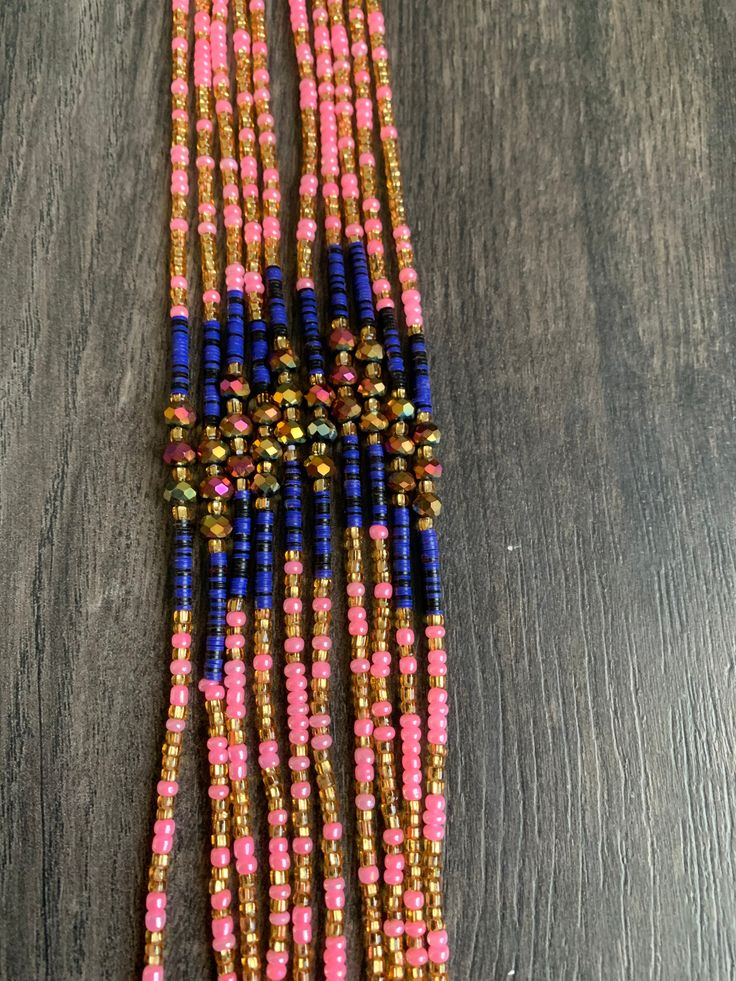 Introducing 'Meryl,' where pink, gold, and purple unite in perfect harmony! 🌸✨ Embrace the elegance and energy of these waist beads that bear her name. Adorn yourself with Meryl and celebrate the beauty of color and style. These beads are exclusively available in a tie-on style, constructed using durable cotton/polyester threads. They measure 45"-50” in length and can be self-adjusted to fit your waist size. ★ The prices listed are for a single strand. If you wish to purchase multiple strands, Pink Spacer Bead Necklaces For Festivals, Pink Spacer Beads Necklace For Festival, Pink Spacer Beaded Necklace For Festivals, Adjustable Pink Waist Beads With Spacer Beads, Pink Multi-strand Jewelry With Polished Beads, Pink Spacer Beads For Festival, Spiritual Multicolor Waist Beads With Tiny Beads, Traditional Pink Jewelry With Tiny Beads, Pink Waist Beads For Festivals