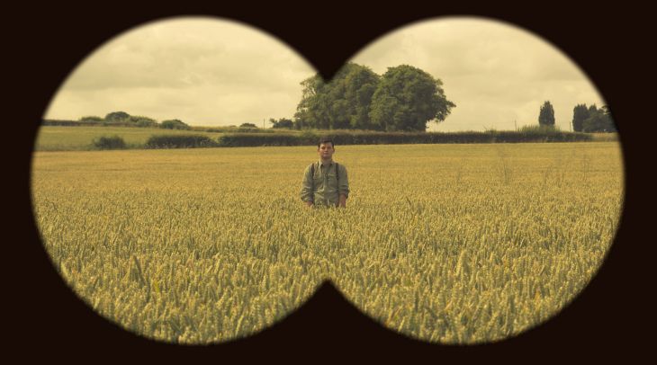 a man standing in the middle of a wheat field