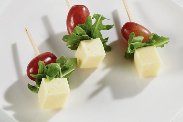 small appetizers with cheese, tomato and lettuce on skewers