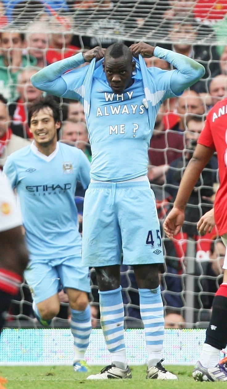 two soccer players are standing in front of the net and one is covering his head with his hands