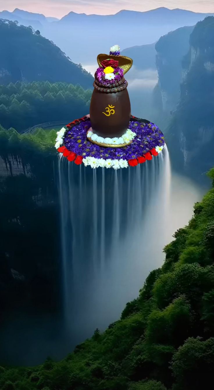 a chocolate cake floating in the air over a waterfall with trees and mountains behind it