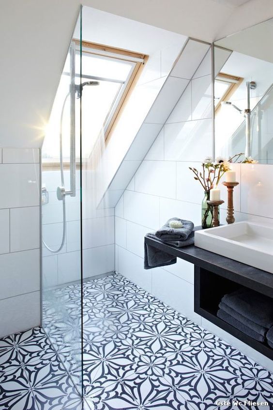 a bathroom with a skylight and tiled floor