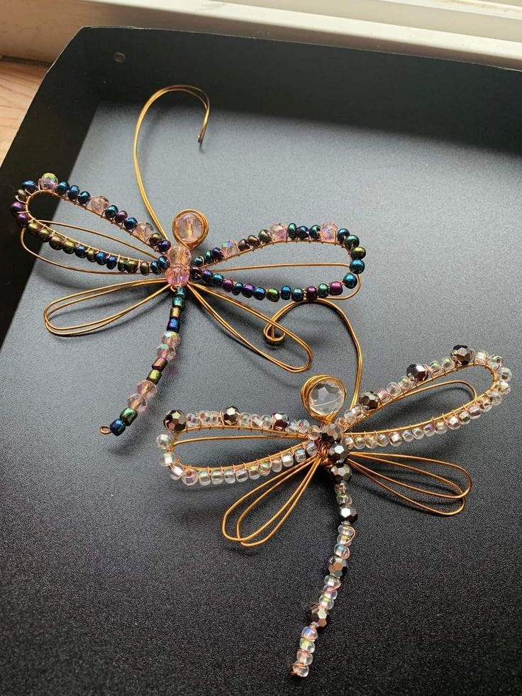 a dragonfly brooch sitting on top of a table