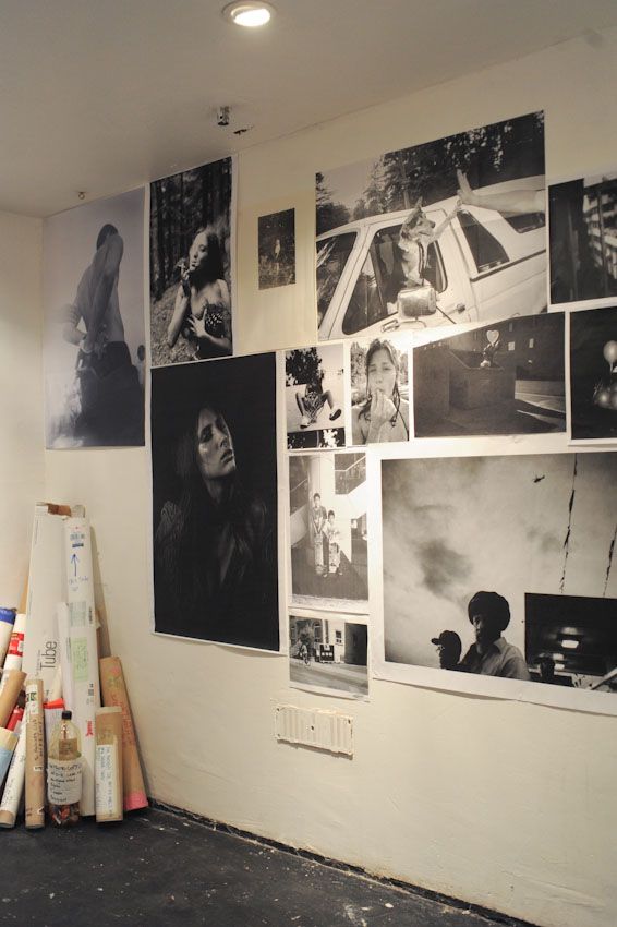 the wall is covered with black and white photos