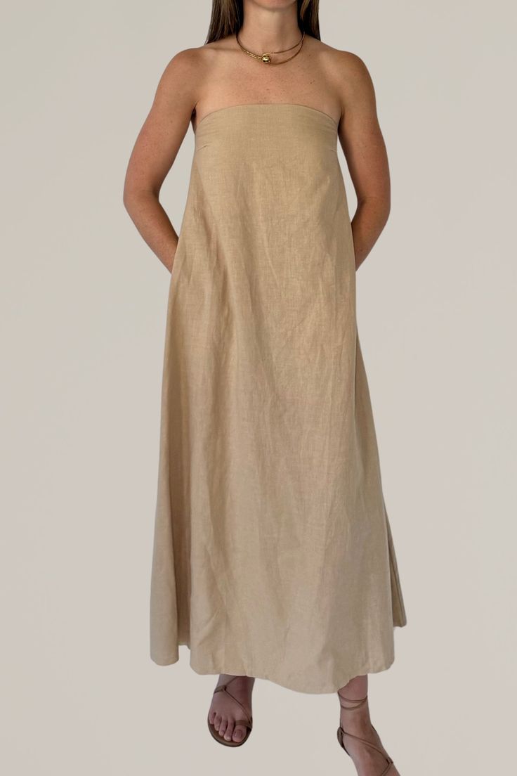 this linen strapless column dress is a must have for your summer wardrobe. crafted from a luxurious linen blend, this maxi dress offers a perfect combination of comfort and elegance. the strapless design and flowing silhouette create a chic and effortless look, ideal for warm weather occasions. whether you're heading to a beach party or a casual brunch, this versatile dress will keep you cool and stylish all day long. 80% linen | 20% viscose gentle wash cold | lay flat to dry | do not iron model Summer Maxi Dress With Straight Neckline, Solid Linen Maxi Dress For Vacation, Casual Maxi Dress With Straight Neckline, Strapless Beige Maxi Dress, Elegant Strapless Dress With Straight Neckline For Beach, Linen Chic Maxi Dress, Summer Strapless Linen Dress, Strapless Linen Summer Dress, Beige Strapless Sundress Maxi Dress