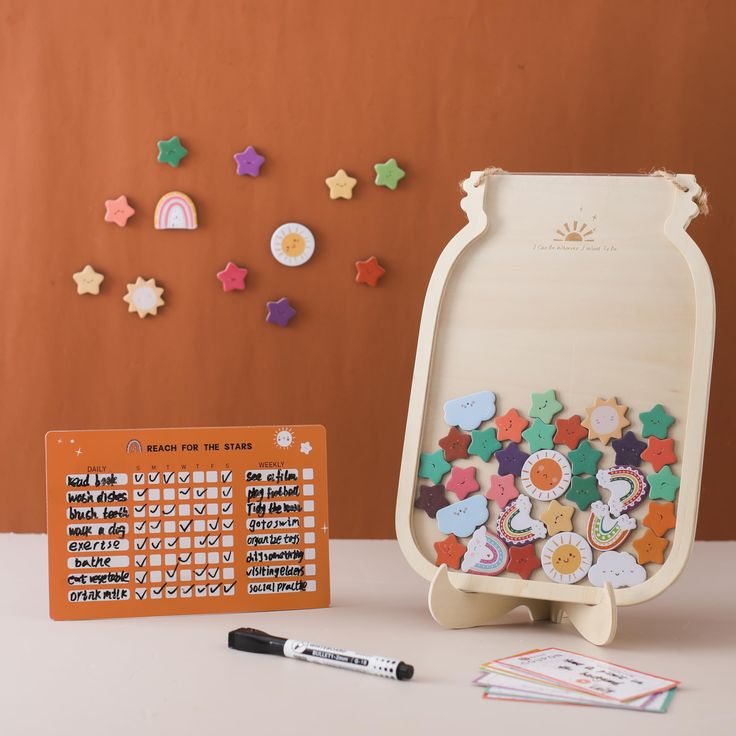 an assortment of magnets and stickers sitting on a table next to a board