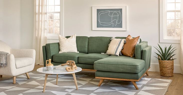 a living room with two couches and a coffee table in front of the window