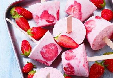 strawberries and marshmallows are arranged on skewers